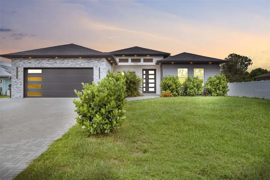 Front exterior of a new home in , North Port, FL, highlighting curb appeal (Image 1). Front exterior of a new home in , North Port, FL, highlighting curb appeal (Image 1).