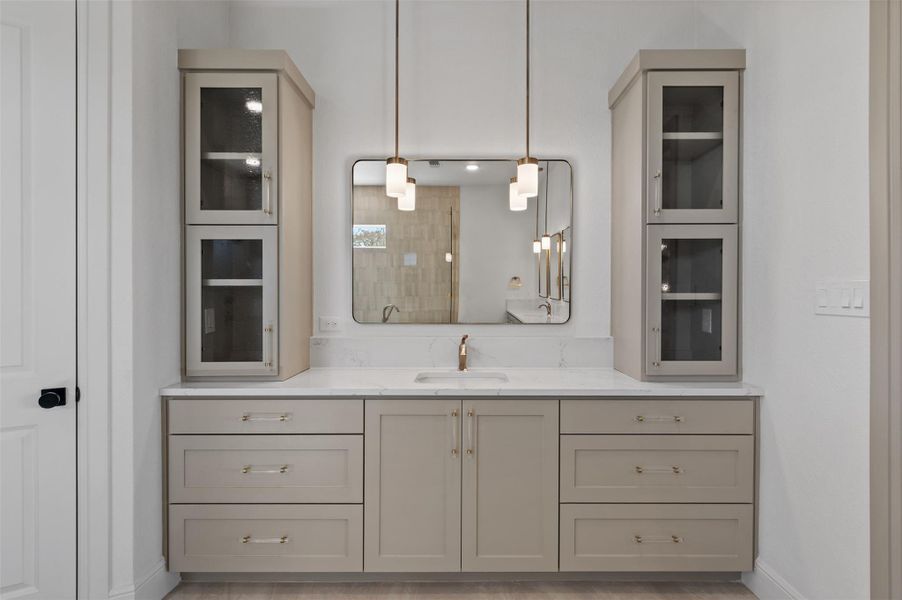 Full bath featuring a tile shower and vanity