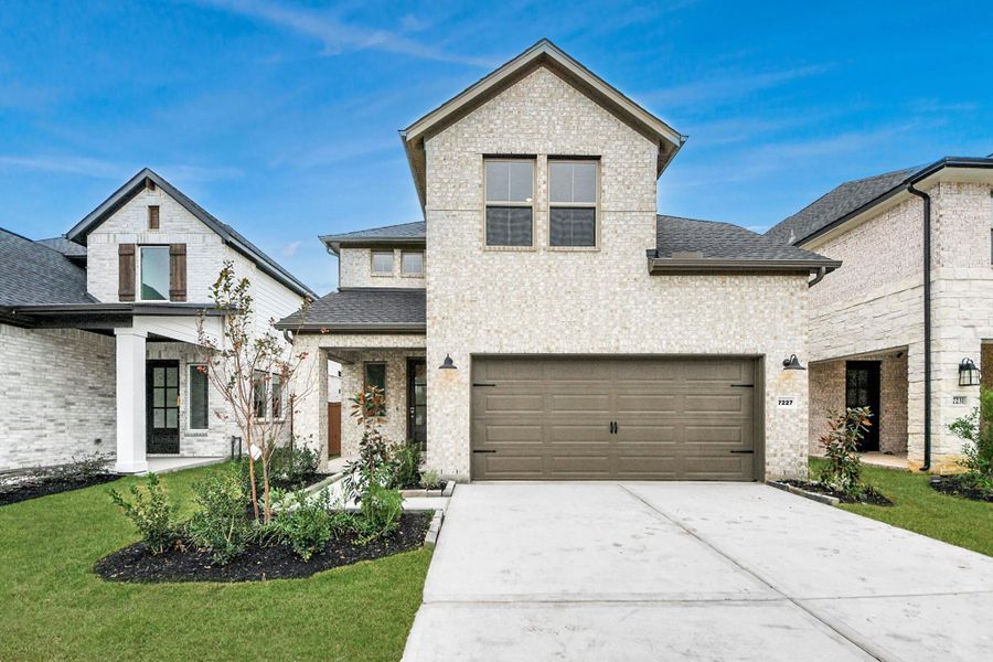 Front exterior of a new home in Elyson, Katy, TX, highlighting curb appeal (Image 2).