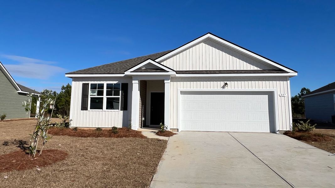 Front exterior of a new home in Meadow Walk, Loris, SC, highlighting curb appeal (Image 1).