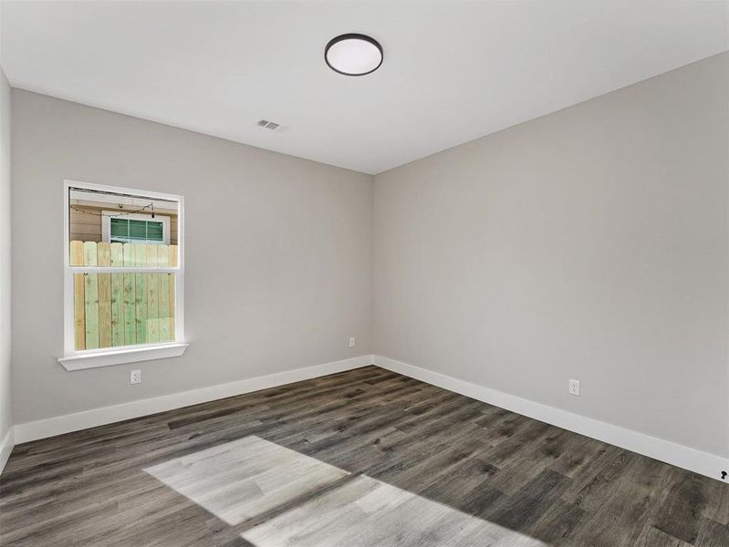 Spare room featuring dark hardwood / wood-style flooring