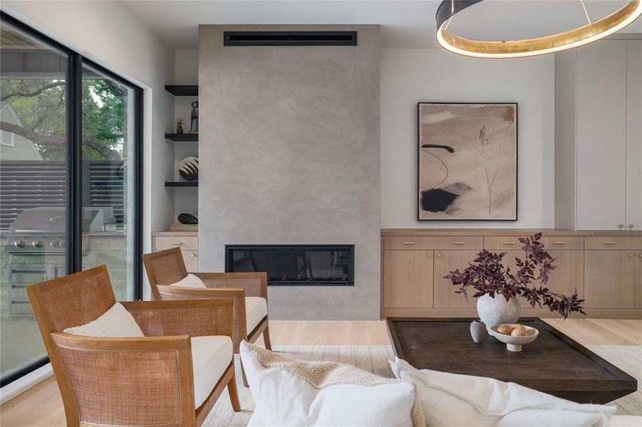 The living room is distinguished by the 60" linear gas fireplace, encased in stunning Venetian plaster.