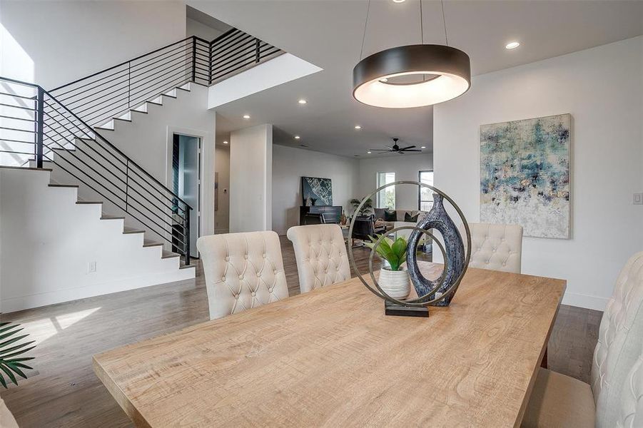 Dining space with stairs, recessed lighting, baseboards, and wood finished floors