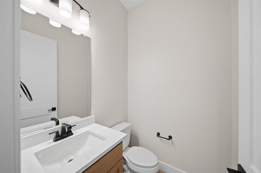Half bath with vanity and toilet