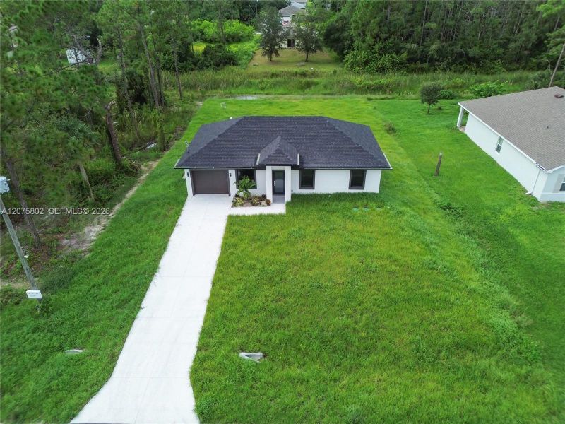 Front exterior of a new home in , Lehigh Acres, FL, highlighting curb appeal (Image 21).