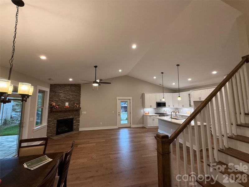 Dining Room, Great Room, Kitchen and Stairs to Bonus Room. Looking out sliders to Covered Patio in Rear Dining Room, Great Room, Kitchen and Stairs to Bonus Room. Looking out sliders to Covered Patio in Rear