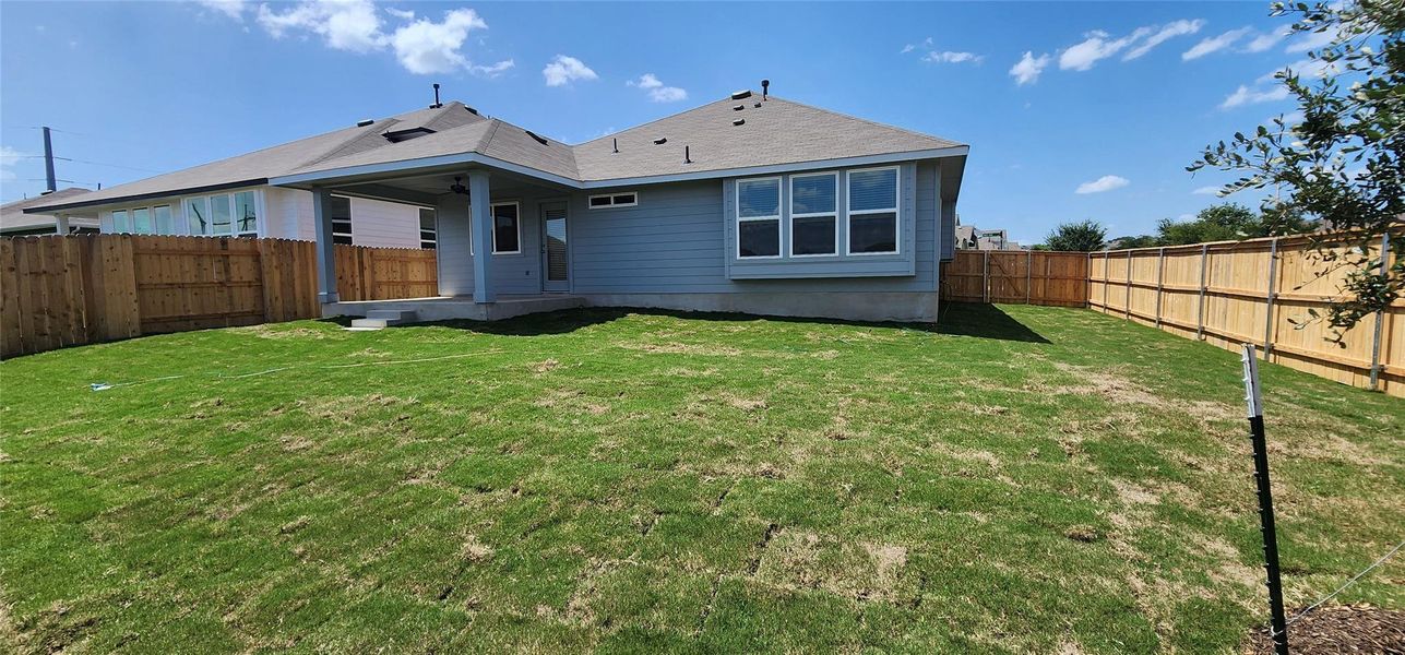 Back of house featuring a fenced backyard and a patio area Back of house featuring a fenced backyard and a patio area