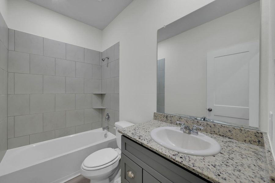 Full bathroom conveniently located near secondary bedrooms, with updated vanity/fixures. Full bathroom conveniently located near secondary bedrooms, with updated vanity/fixures.