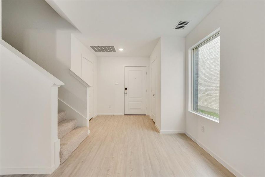 Entrance foyer featuring a healthy amount of sunlight and light hardwood / wood-style floors