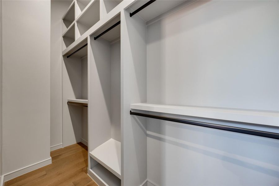 Owners large walk-in closet with 10 ft ceiling built-in system