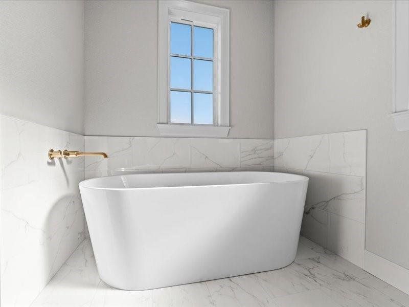 Bathroom featuring a freestanding tub, wainscoting, marble finish flooring, and tile walls Bathroom featuring a freestanding tub, wainscoting, marble finish flooring, and tile walls