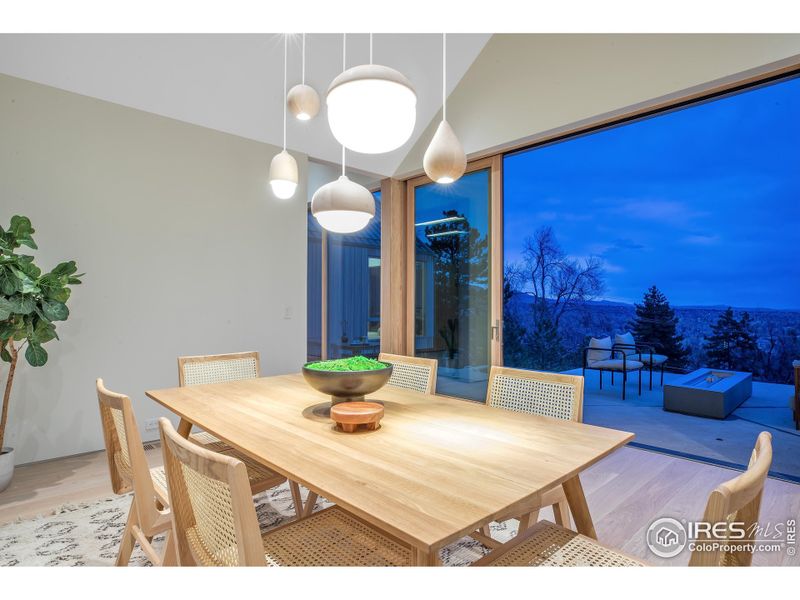 Dining room overlooking heated patio / firepit / city views