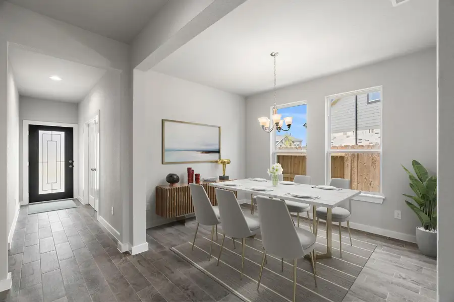 *Virtually Staged* Create lasting memories gathered around the table with family and friends in this spacious dining room. Enhanced by elegant flooring and custom paint, its adjacent to the family room and kitchen, fostering an open-concept atmosphere for shared moments.