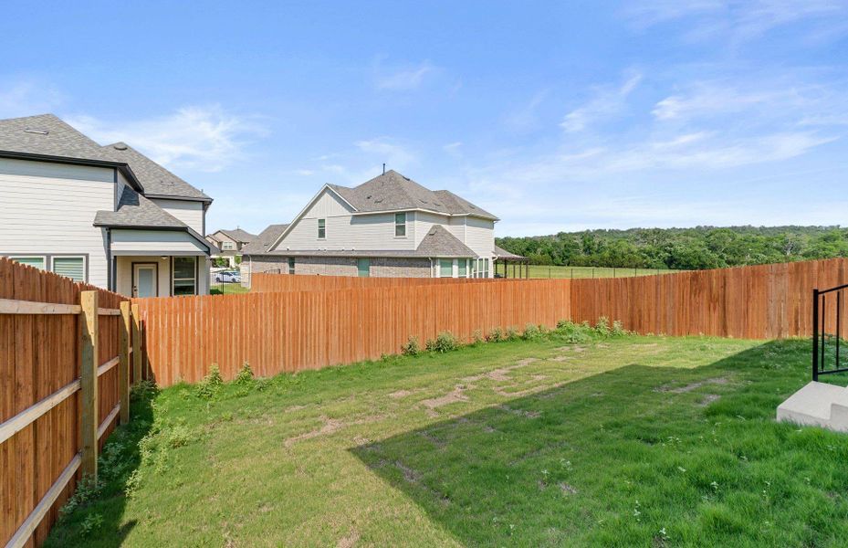 Front exterior of a new home in Saddleback at Santa Rita Ranch, Liberty Hill, TX, highlighting curb appeal (Image 12). Front exterior of a new home in Saddleback at Santa Rita Ranch, Liberty Hill, TX, highlighting curb appeal (Image 12).