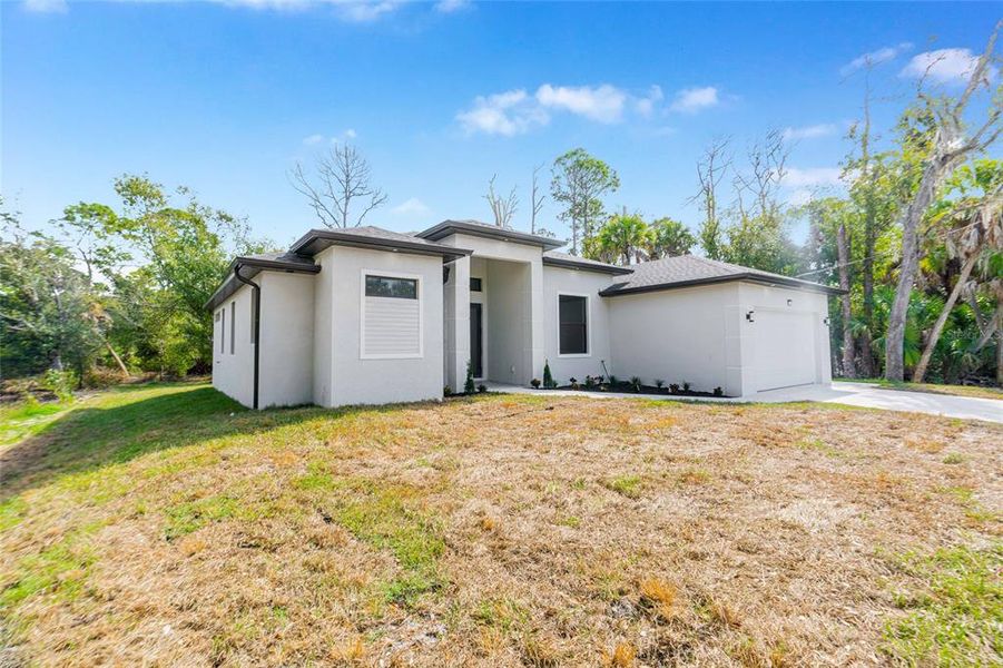 Front exterior of a new home in , Port Charlotte, FL, highlighting curb appeal (Image 23).