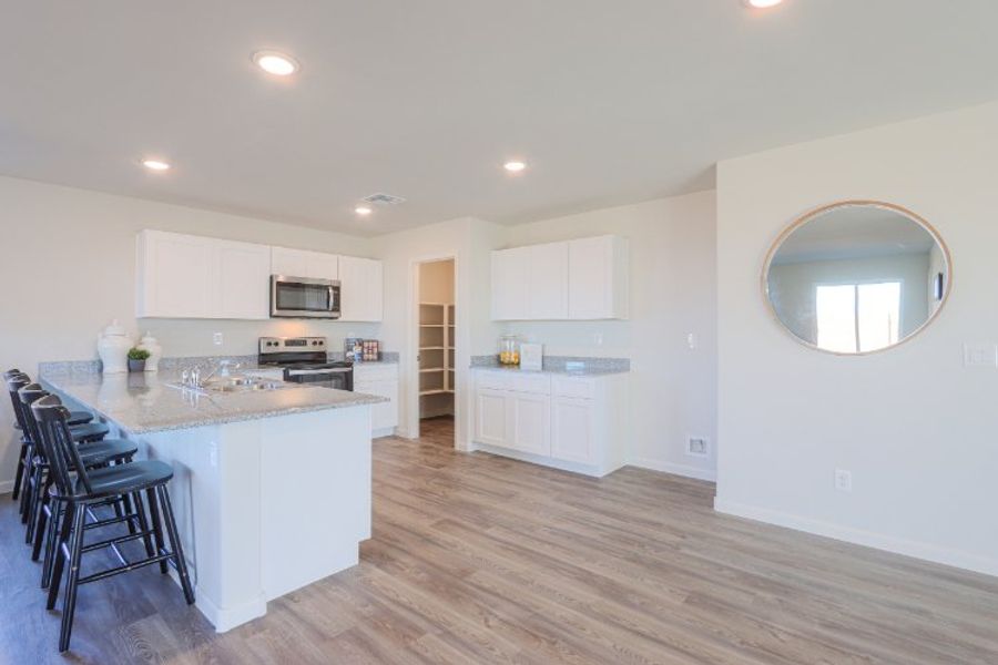 A kitchen with white cabinets.