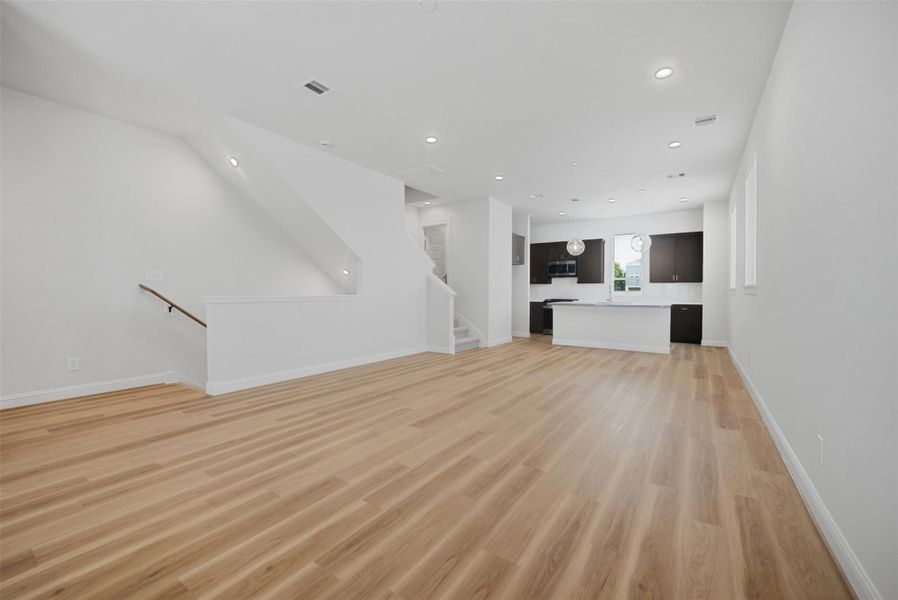 Experience seamless open-concept living with a spacious layout uniting the living, dining, and kitchen areas, perfect for entertaining and daily comfort.