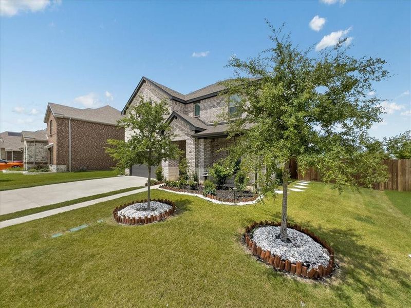 View of front of property featuring a garage and a front yard