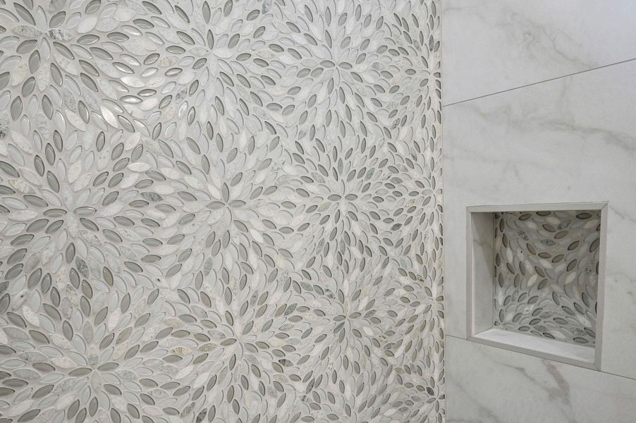 Intricate floral mosaic tile adds a designer touch and texture to the space. Intricate floral mosaic tile adds a designer touch and texture to the space.
