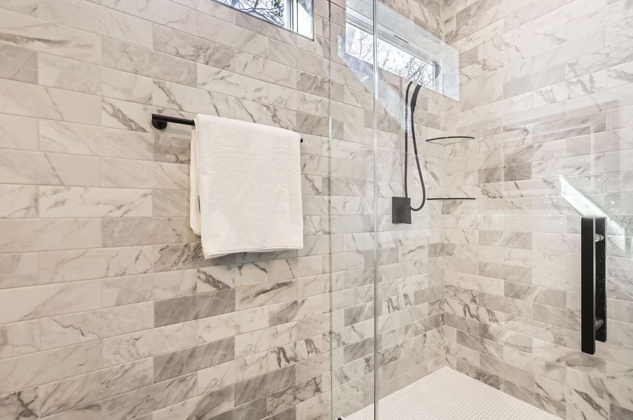 Walk-in shower with contemporary design, offering both a modern aesthetic and functionality.