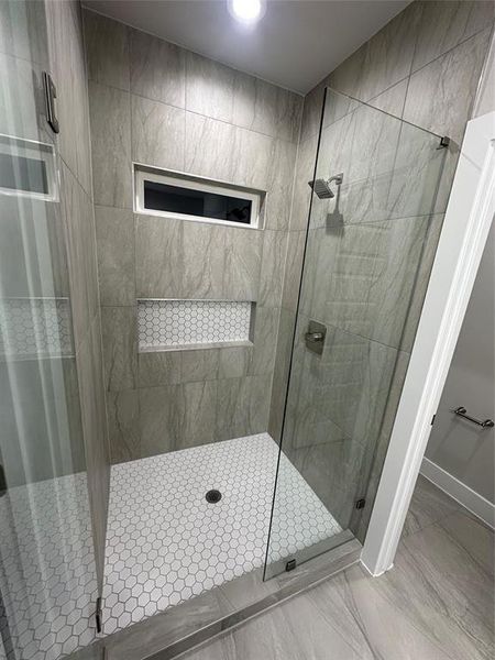 Bathroom with tile floors and an enclosed shower