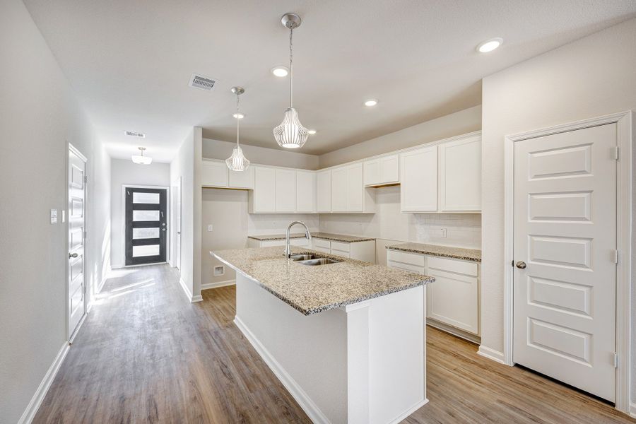 Kitchen and Foyer. Sample image for illustration; upgrades, options, and colors may vary. Kitchen and Foyer. Sample image for illustration; upgrades, options, and colors may vary.