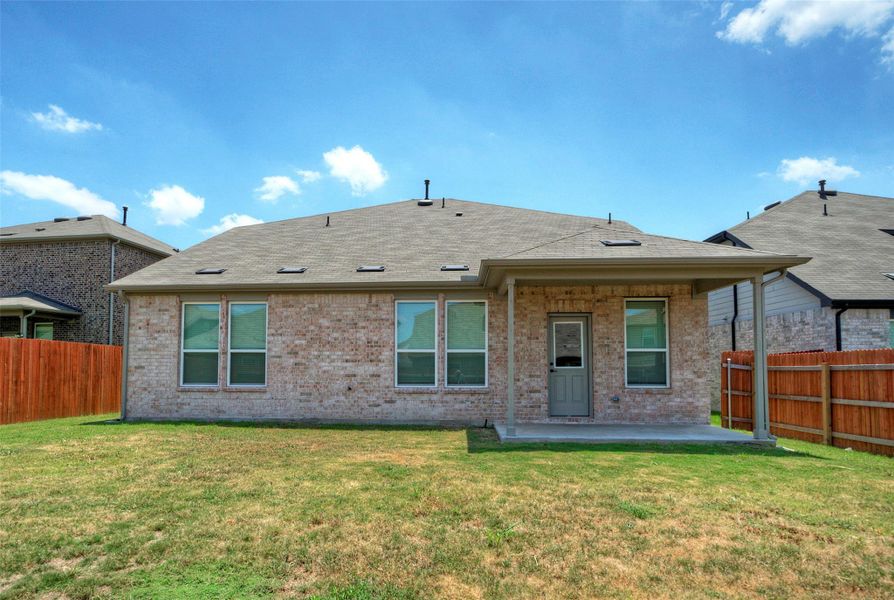 A private backyard oasis awaits, featuring a covered patio perfect for outdoor enjoyment and a well-maintained lawn for leisure. A private backyard oasis awaits, featuring a covered patio perfect for outdoor enjoyment and a well-maintained lawn for leisure.