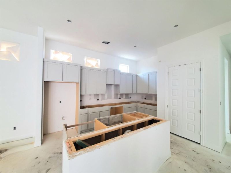 Kitchen featuring a center island and concrete floors