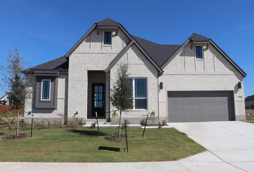 Front exterior of a new home in Bull Hide Estates, Hewitt, TX, highlighting curb appeal (Image 1).
