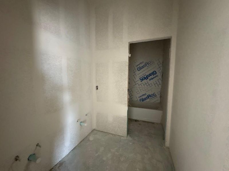 Bathroom with unfinished concrete flooring Bathroom with unfinished concrete flooring