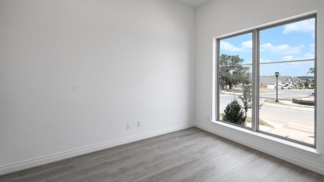 Spare room featuring wood finished floors and baseboards Spare room featuring wood finished floors and baseboards
