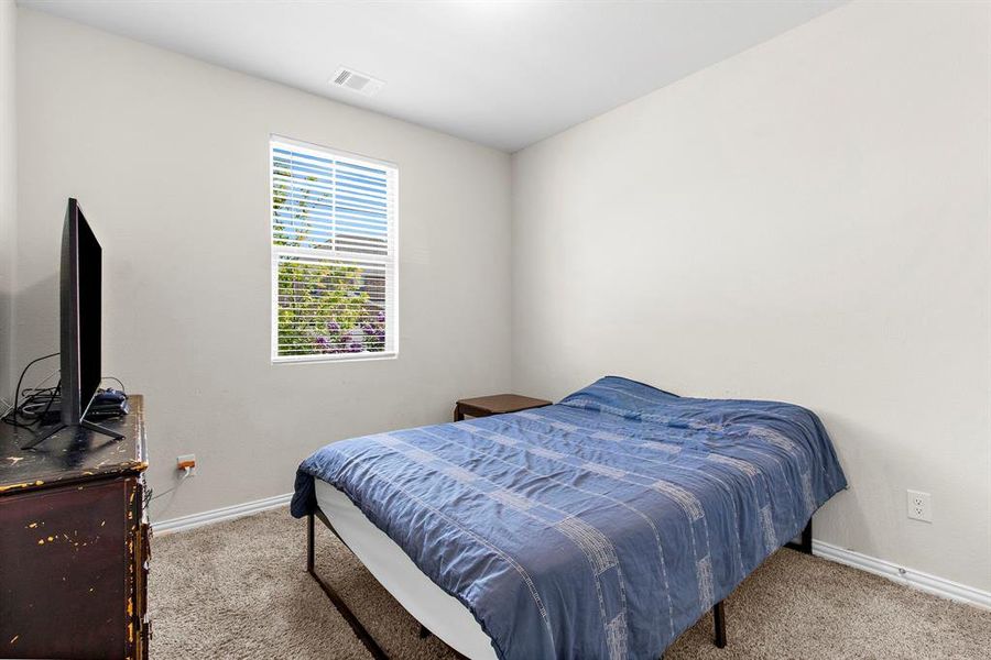 Carpeted bedroom with baseboards Carpeted bedroom with baseboards