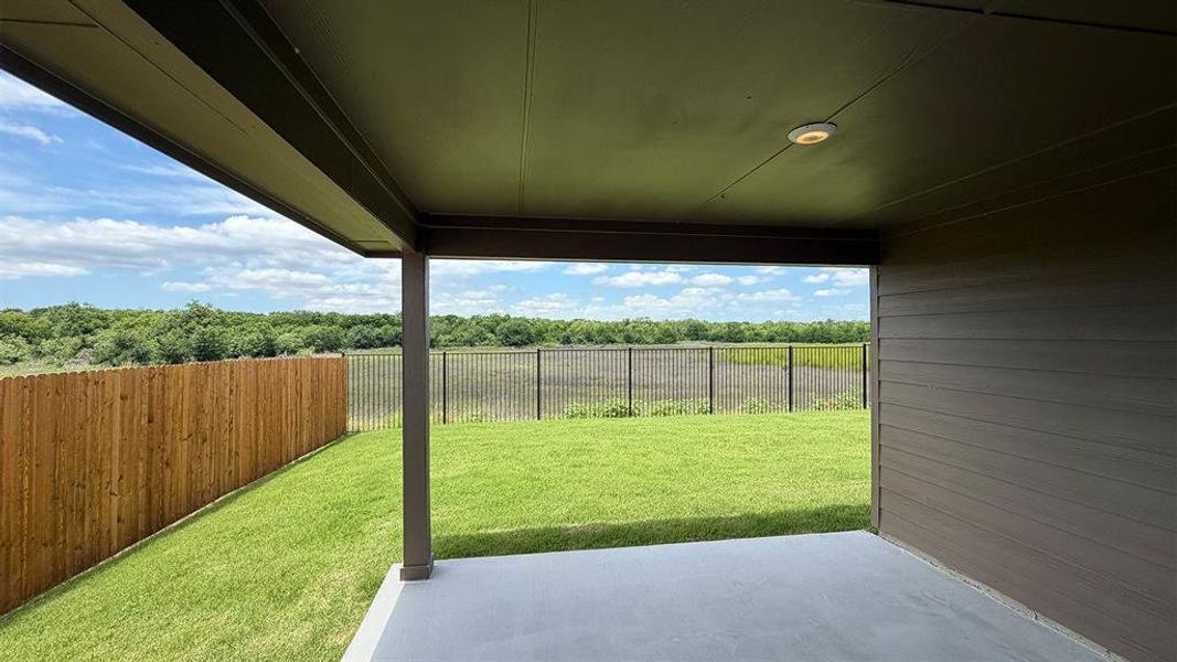 Covered patio featuring a concrete slab, recessed lighting, and a dark-finished ceiling