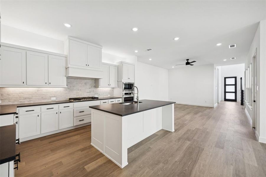 The spacious kitchen island creates the perfect place for friends and family to gather round.
