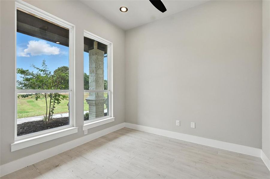 Empty room with wood finished floors and ceiling fan