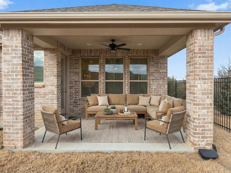 Virtually staged view of patio / terrace featuring ceiling fan and outdoor seating