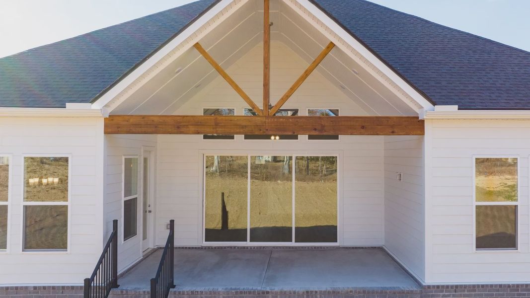 Wood beam accent on covered back porch