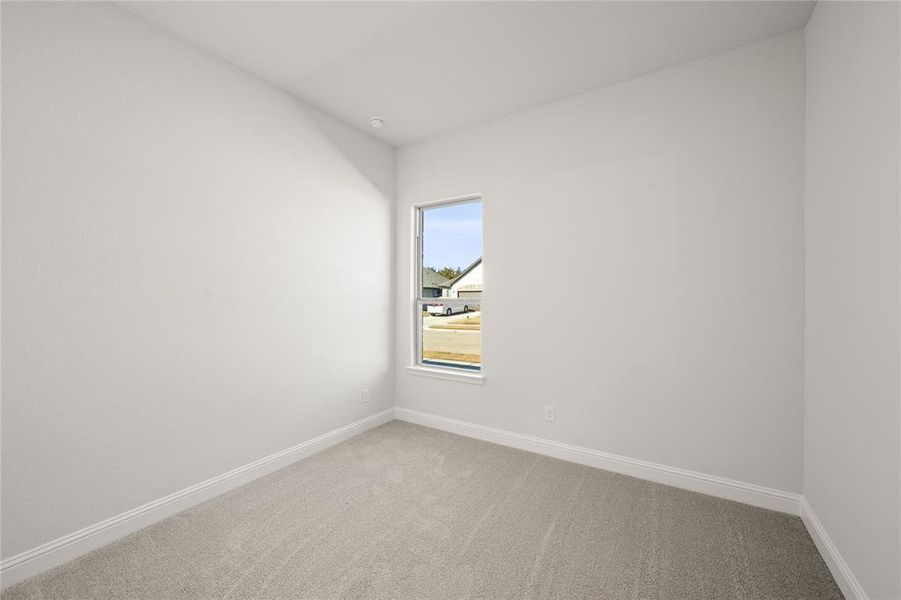 Secondary bedroom featuring carpet floors