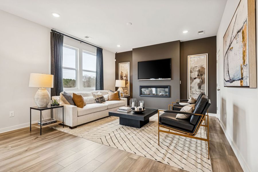 A living room with a wood floor. A living room with a wood floor.