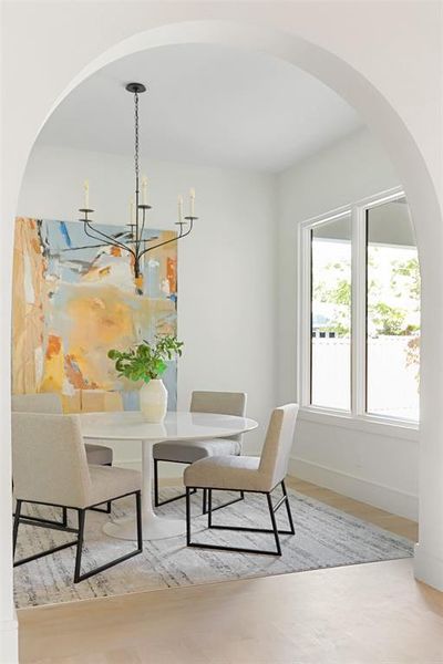 Dining area featuring a chandelier and light wood-type flooring