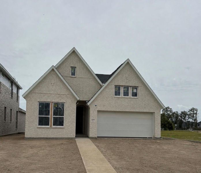 Front exterior of a new home in Woodson’s Reserve, Spring, TX, highlighting curb appeal (Image 1). Front exterior of a new home in Woodson’s Reserve, Spring, TX, highlighting curb appeal (Image 1).
