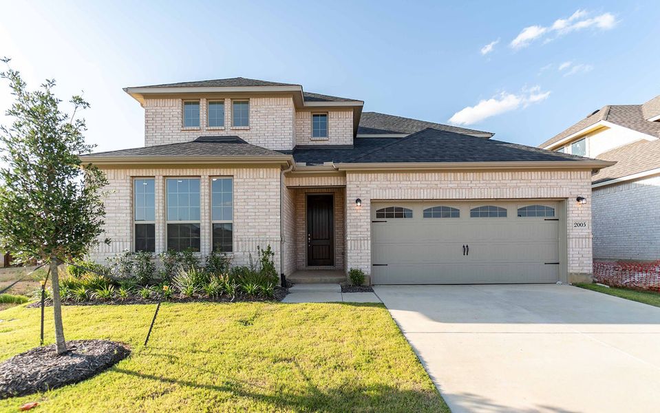 Front exterior of a new home in La Terra, Celina, TX, highlighting curb appeal (Image 1). Front exterior of a new home in La Terra, Celina, TX, highlighting curb appeal (Image 1).
