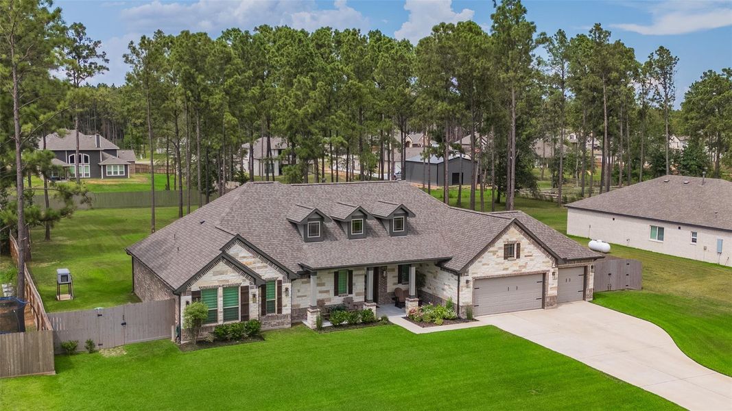 Front exterior of a new home in Deer Pines, Conroe, TX, highlighting curb appeal (Image 21).