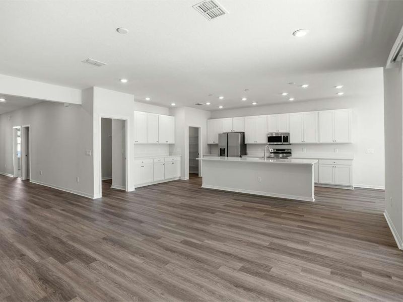 Enjoy a light-filled open living area - Everly by Highland Homes