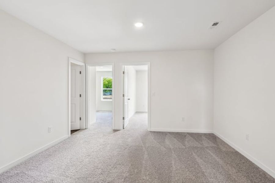 A hallway with white doors.