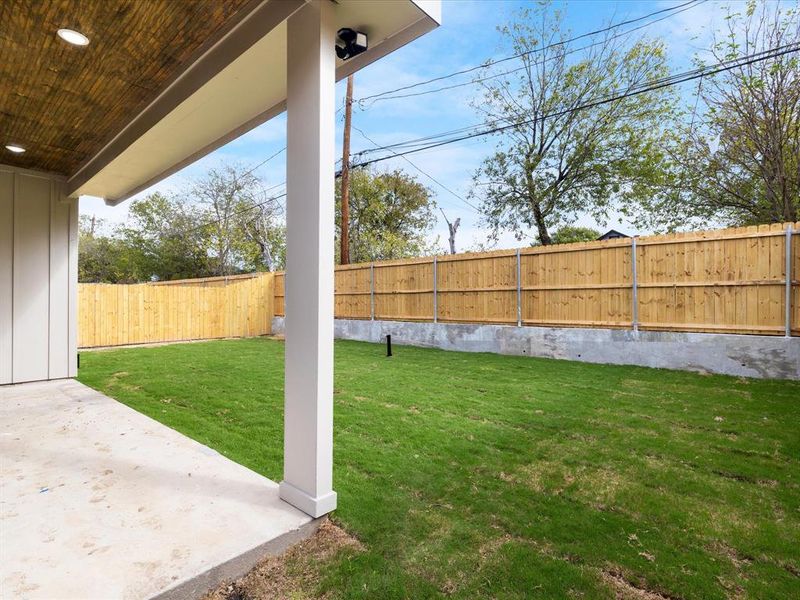 Fenced backyard with a patio area
