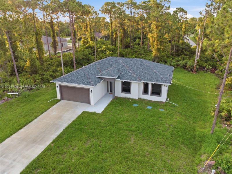 Front exterior of a new home in , Lehigh Acres, FL, highlighting curb appeal (Image 28).