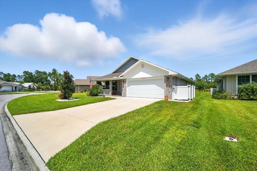 Front exterior of a new home in Sawmill Creek at Palm Coast Park, Palm Coast, FL, highlighting curb appeal (Image 23).