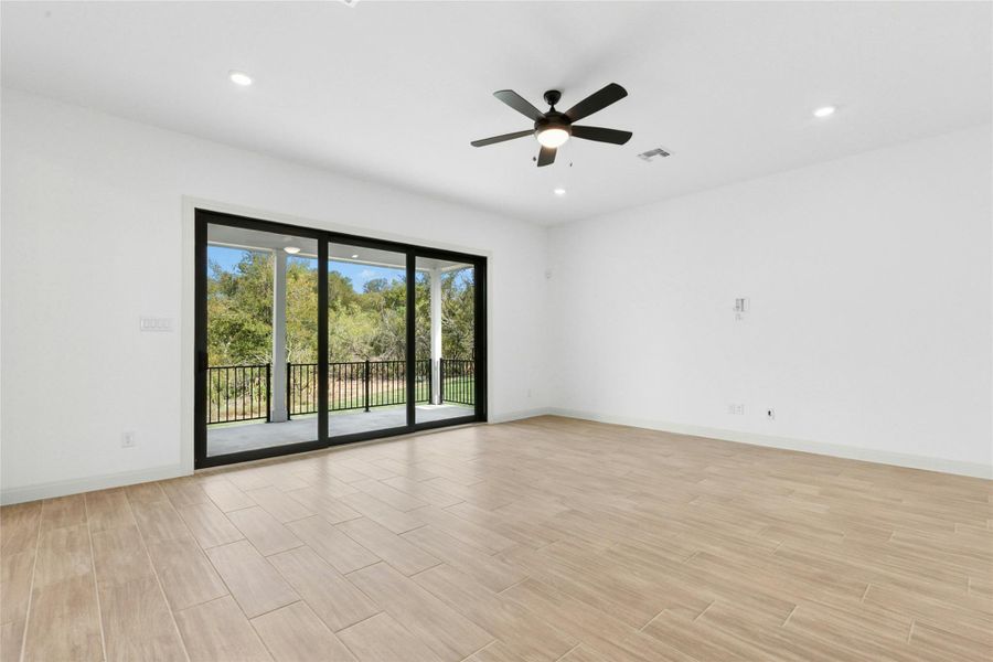 Empty room with recessed lighting, wood tiled floors, and a ceiling fan Empty room with recessed lighting, wood tiled floors, and a ceiling fan