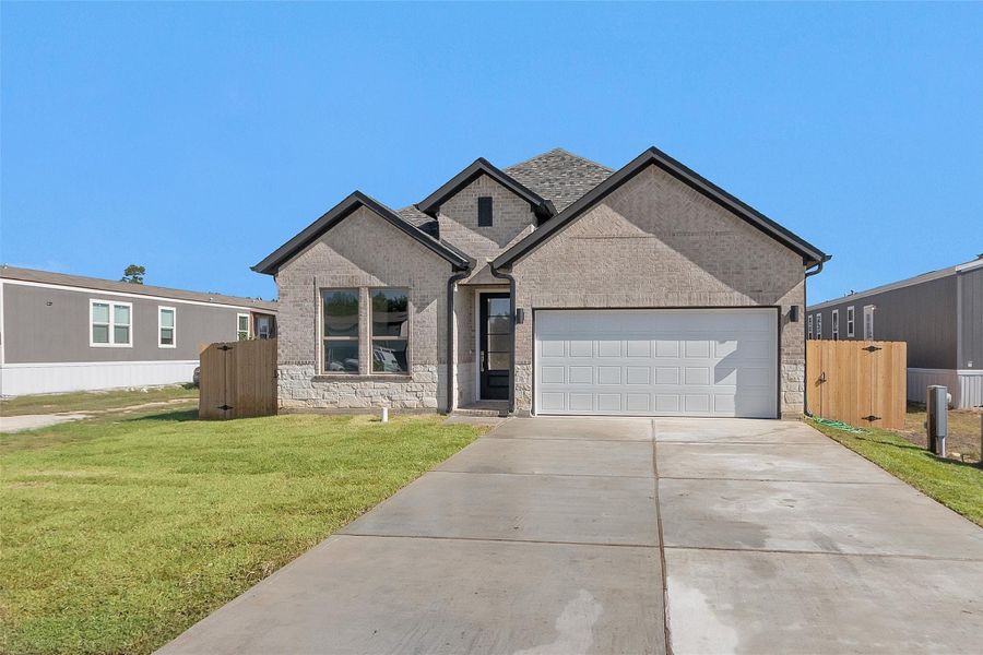 Front exterior of a new home in , Cleveland, TX, highlighting curb appeal (Image 16).